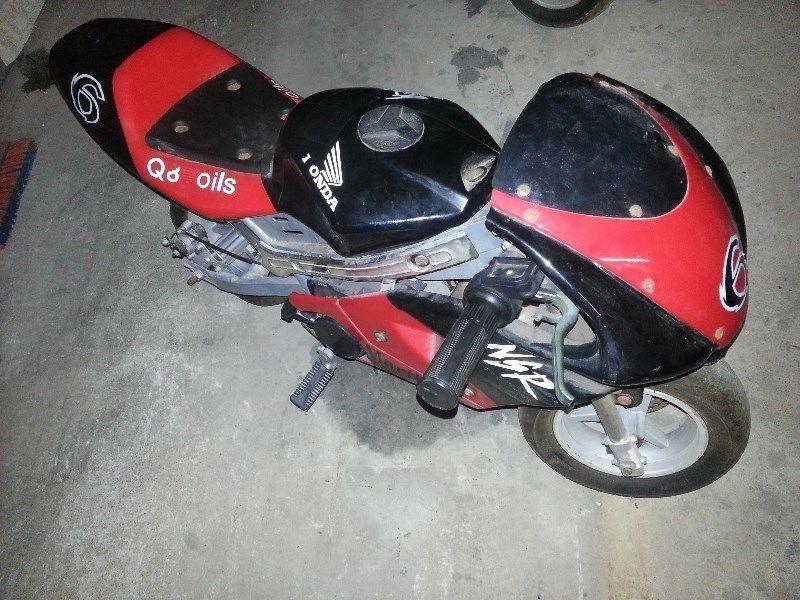pocket bike for sale. Red and used only once. The protective plastic is still on some parts